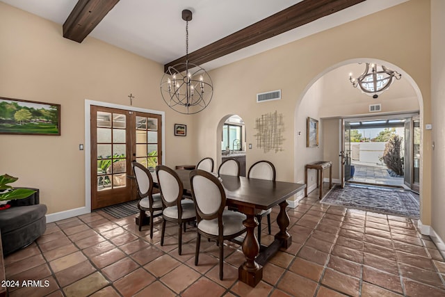 dining room featuring french doors, a towering ceiling, a notable chandelier, and beam ceiling