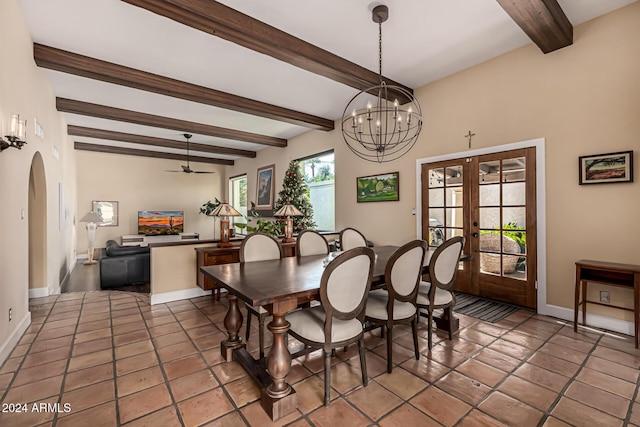 tiled dining space with ceiling fan with notable chandelier, beam ceiling, a wealth of natural light, and french doors