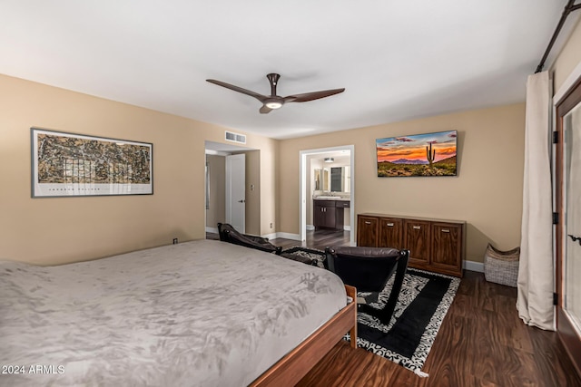 bedroom with dark hardwood / wood-style flooring, ceiling fan, and connected bathroom