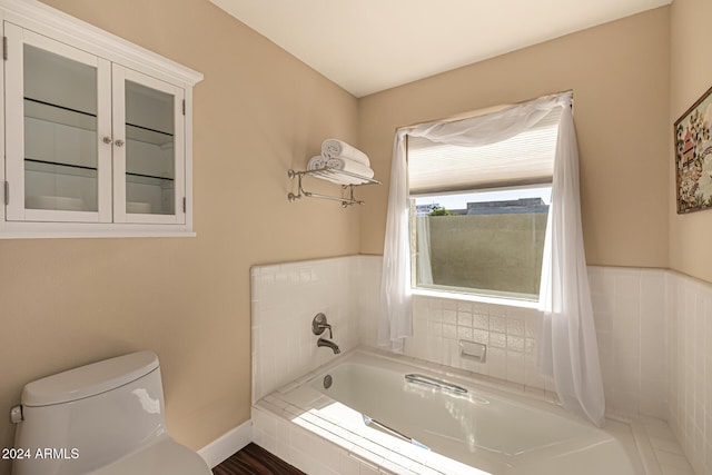 bathroom with tiled bath and toilet