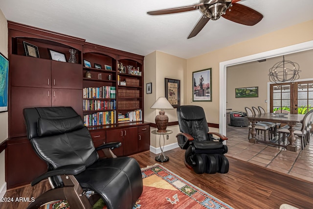 living area featuring ceiling fan, hardwood / wood-style floors, and french doors