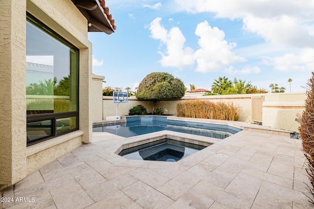 view of pool with a patio area and an in ground hot tub