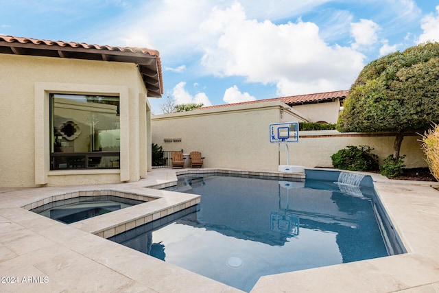 view of swimming pool featuring an in ground hot tub