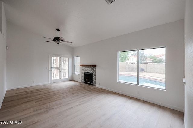 unfurnished living room with ceiling fan, lofted ceiling, and light hardwood / wood-style flooring