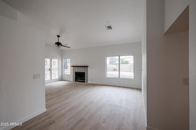 unfurnished living room featuring ceiling fan, light hardwood / wood-style floors, and a healthy amount of sunlight