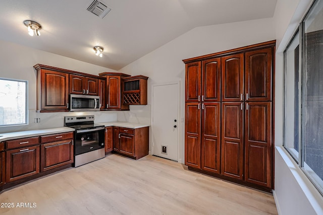 kitchen with open shelves, lofted ceiling, light countertops, visible vents, and appliances with stainless steel finishes