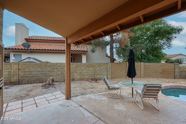 view of patio with a fenced in pool