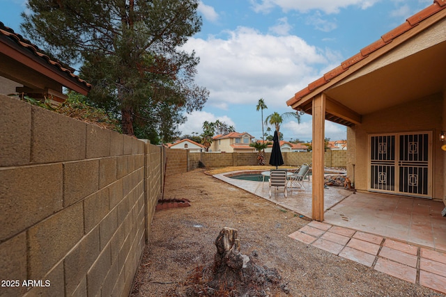 view of yard with a fenced backyard and a patio