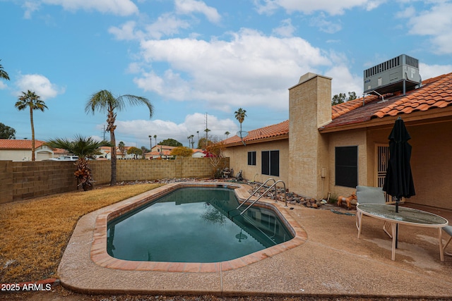 view of pool with central AC unit and a patio