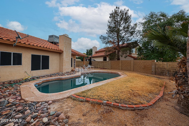 view of swimming pool with a fenced in pool, a fenced backyard, and a patio