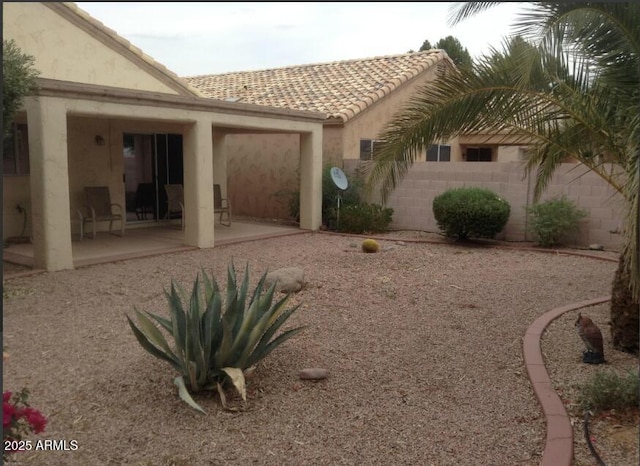 view of yard featuring a garage, a patio, and fence