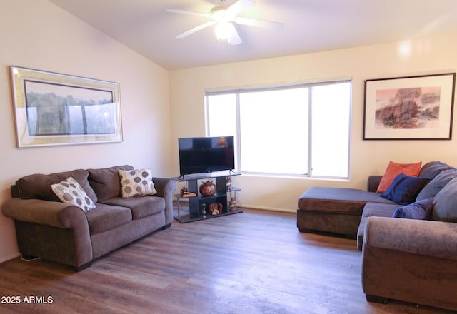 living room featuring ceiling fan, vaulted ceiling, and wood-type flooring