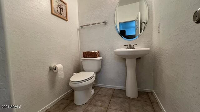 bathroom featuring tile patterned floors, toilet, and sink