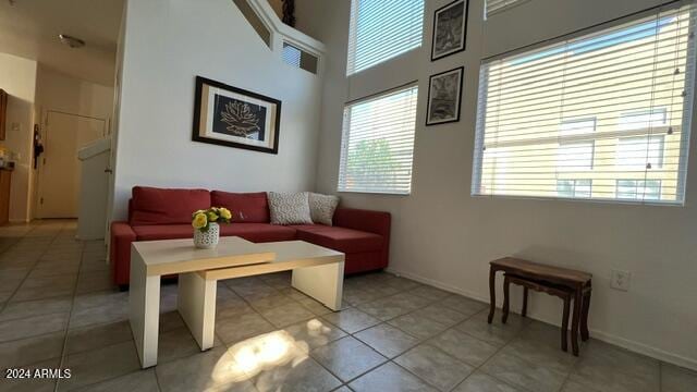 tiled living room with a high ceiling