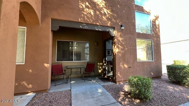 view of exterior entry featuring a patio area