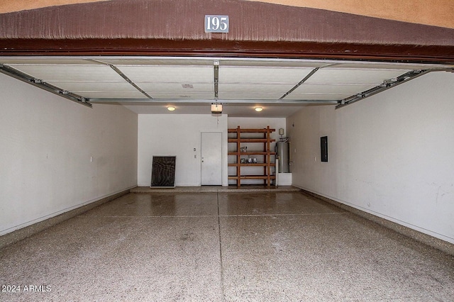 garage featuring water heater, a garage door opener, and electric panel