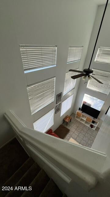 unfurnished living room featuring ceiling fan