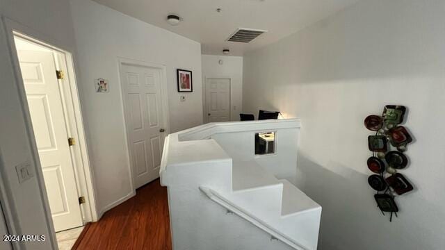 hallway with dark hardwood / wood-style flooring