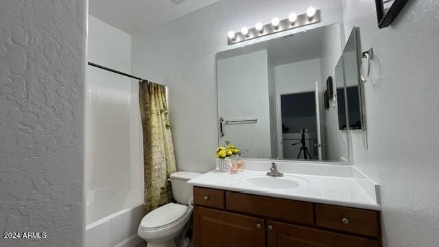 full bathroom with vanity, shower / bathtub combination with curtain, and toilet