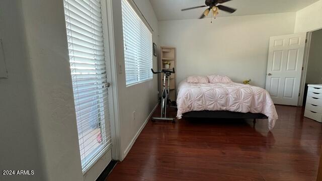 bedroom with dark hardwood / wood-style flooring and ceiling fan