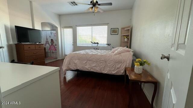 bedroom with dark hardwood / wood-style flooring and ceiling fan