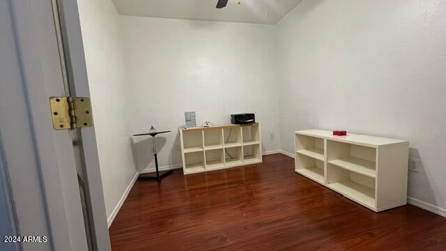 interior space featuring dark wood-type flooring and ceiling fan