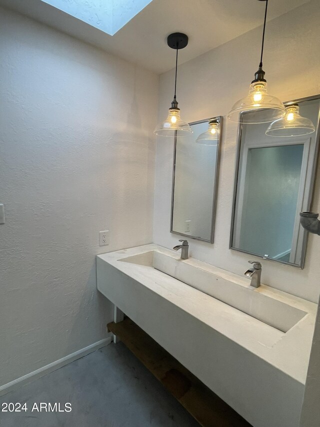 bathroom featuring vanity and a skylight