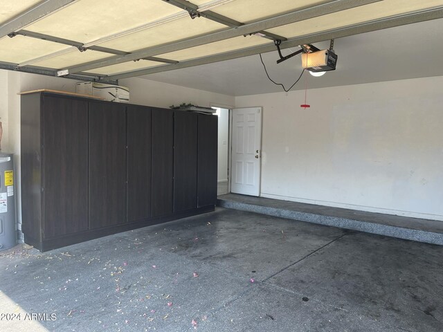 garage featuring water heater and a garage door opener