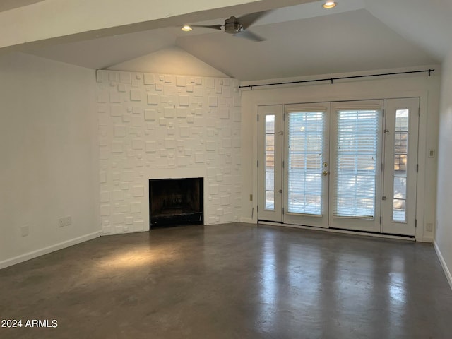 unfurnished living room featuring ceiling fan, a wealth of natural light, a fireplace, and vaulted ceiling