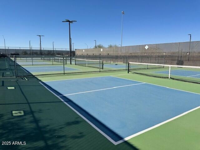 view of sport court with fence