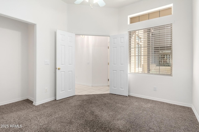 unfurnished bedroom featuring ceiling fan and light carpet