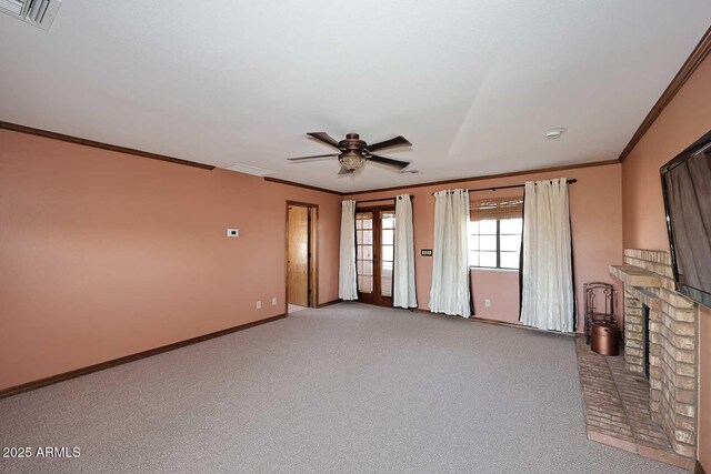 11215 N Garland Cir, Fountain Hills, AZ 85268 - unfurnished living room featuring ceiling fan, light colored carpet, visible vents, a fireplace, and ornamental molding