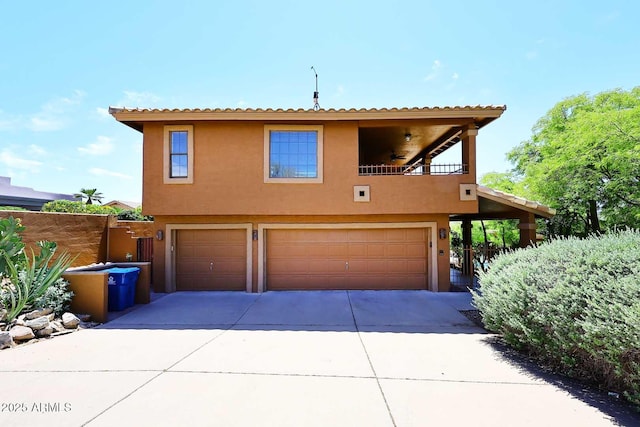 11215 N Garland Cir, Fountain Hills, AZ 85268 - view of front of property featuring an attached garage, concrete driveway, stucco siding, and a balcony