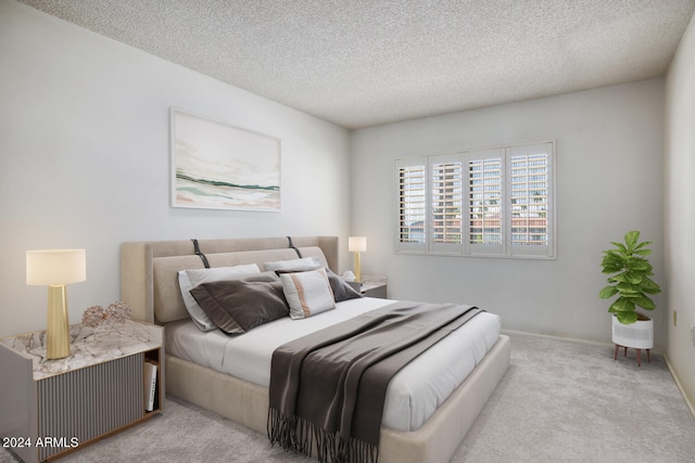 carpeted bedroom featuring a textured ceiling