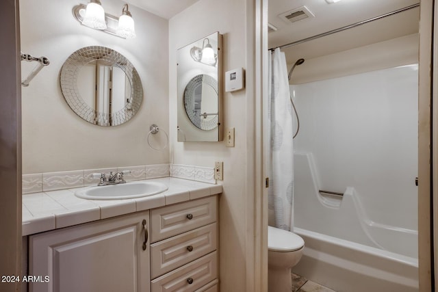 full bathroom with vanity, shower / tub combo, and toilet