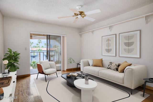 living room featuring ceiling fan, a textured ceiling, and hardwood / wood-style flooring