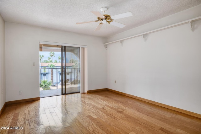 empty room featuring ceiling fan, a textured ceiling, and light wood-type flooring