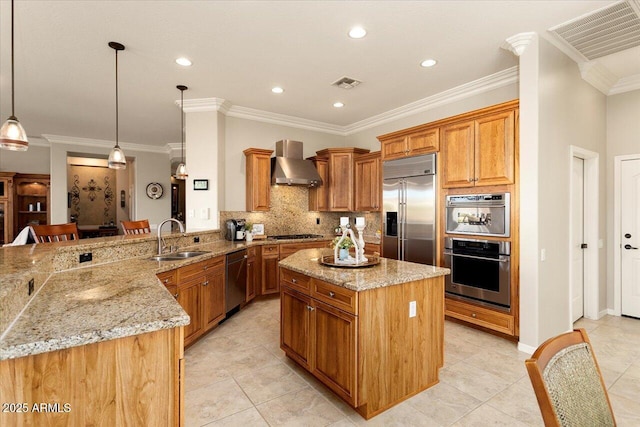 kitchen featuring appliances with stainless steel finishes, sink, a center island, kitchen peninsula, and wall chimney range hood