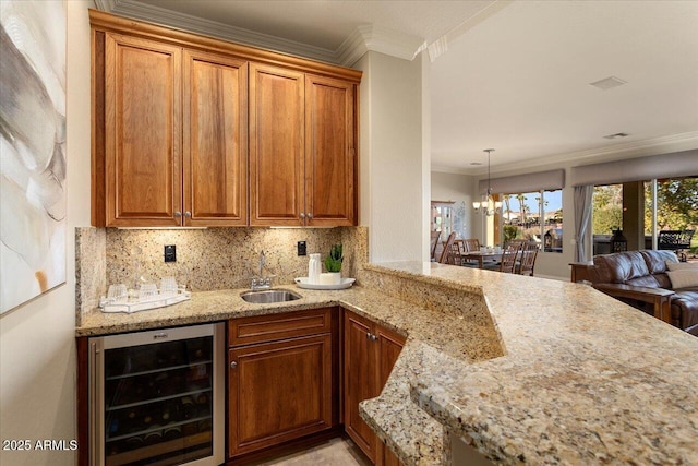 kitchen with sink, wine cooler, decorative backsplash, ornamental molding, and kitchen peninsula