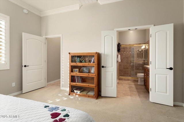 carpeted bedroom featuring ornamental molding and connected bathroom