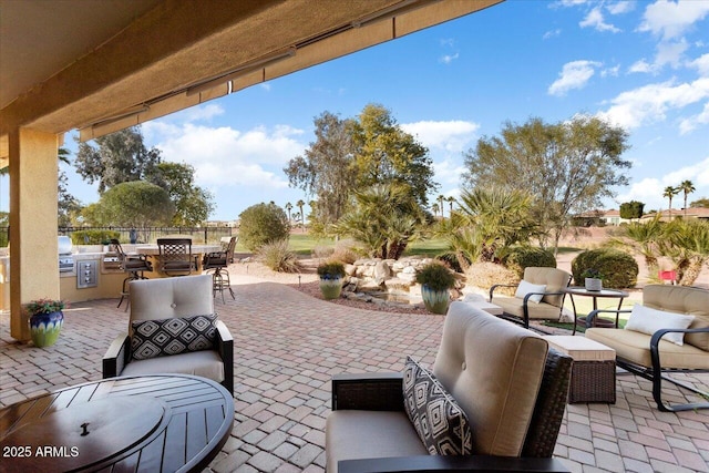 view of patio / terrace with area for grilling, outdoor lounge area, and exterior kitchen