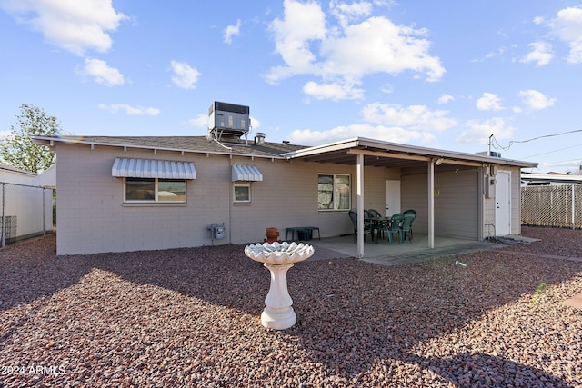 rear view of property featuring cooling unit and a patio area