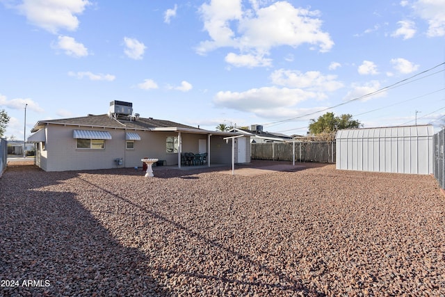 rear view of house with a patio and central air condition unit