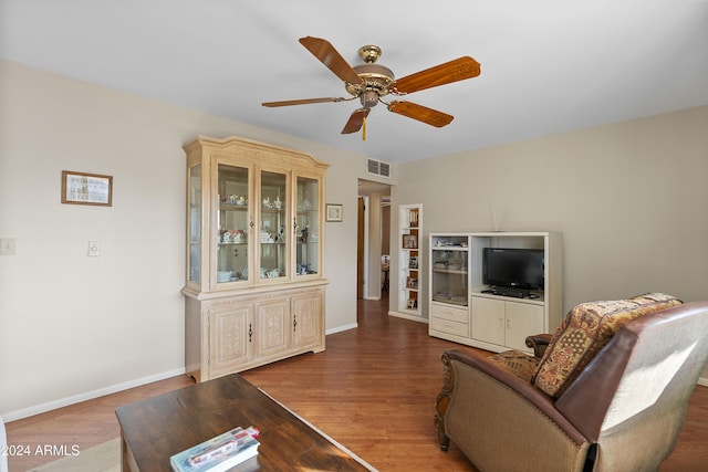 living room with ceiling fan and wood-type flooring