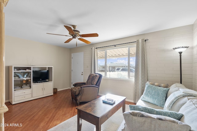 living room featuring hardwood / wood-style floors and ceiling fan