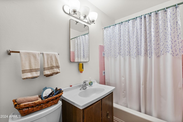 full bathroom featuring shower / bath combo with shower curtain, vanity, and toilet