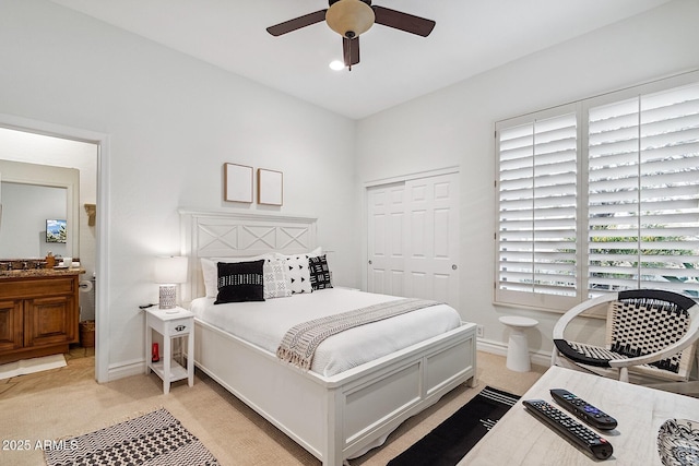 bedroom featuring a closet, baseboards, a ceiling fan, and light colored carpet