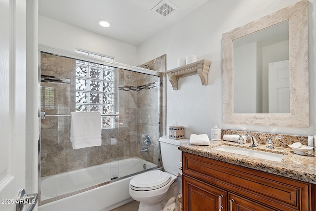 full bath featuring enclosed tub / shower combo, visible vents, vanity, and toilet