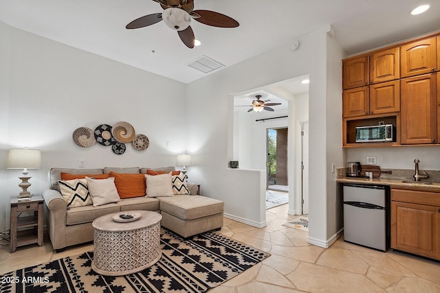 living room with recessed lighting, visible vents, ceiling fan, and baseboards