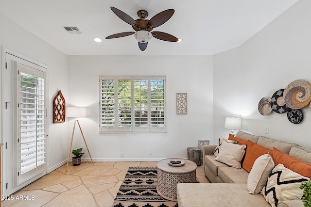 living room featuring a wealth of natural light, visible vents, baseboards, and recessed lighting